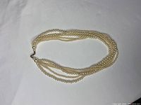 Full image of the layered pearl necklace showing all strands and clasp.