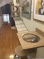 Wall mounted cat gym setup along a hallway including multiple platforms, ramp, and resting bowl shown in context.