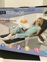 Box of SpaMassage full body massage mat showing woman reclining with the mat and heat function illustration, listing features including dual speed, 5 massage modes, soothing heat.