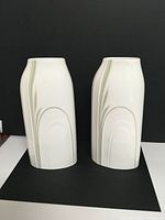 Front view of the two identical white Royal Doulton vases showing the overall shape and line design.