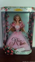 Front view of the Rose Barbie in original packaging showing full doll and box design with rose graphics.