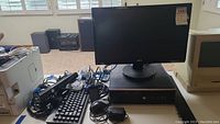 Full view of the lot showing the HP desktop computer tower on desk with Acer monitor on top, black wired keyboard in front, Xbox 360 camera, and various cables.