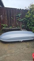 Full side view of the Yakima SkyBox Pro kayak roof cargo box in silver showing overall condition and size.