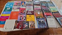 Full assortment of music books and sheet music including jazz, bass, piano, guitar, and percussion instruction books spread out on a table.
