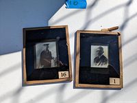 Two framed glass negatives, one featuring a naval sailor and the other an older gentleman, both in black and white.