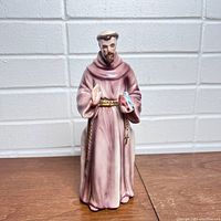 Front view of the Saint Francis ceramic planter figurine with hand-painted details and birds.