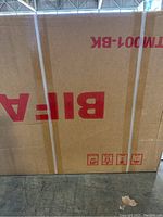 Unopened cardboard box packaging showing BiFanuo branding and model TM001-BK with white strapping