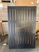 Top view of rectangular slatted metal table top showing umbrella hole in center.