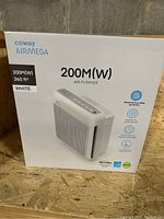 Front view of the Coway Airmega 200M(W) air purifier box showing product image and key features such as True HEPA filter and 360 sq ft coverage.