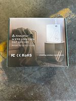 Box image of AromaPlan Scent Diffuser DAP 1001/1002 white model showing product, branding, and certifications