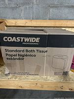 Closed cardboard box labeled 'Coastwide Professional Standard Bath Tissue' showing quantity and product dimensions.