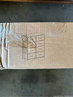 Packaging showing a line drawing of the dresser with eight drawers in two columns.