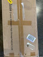 Photo of boxed Fabric 10 Drawer High Storage Cabinet with branding and size details visible.