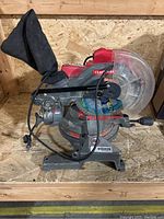 Front side view of Craftsman Master Craft miter saw showing blade, handle and dust collection bag.