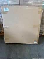 Sealed cardboard box containing the photo light box set, showing plain packaging.