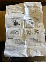 Instruction manual showing installation steps for the roof rack, including diagrams of clamp adjustment and crossbar mounting.