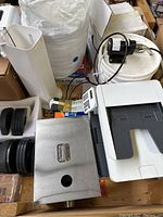 Printer, pump, tower fan, foam roll, stainless steel dispenser, keypad visible