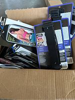 Box containing multiple fitness accessories including active waistbands, armbands, and toning bands, all in original packaging.