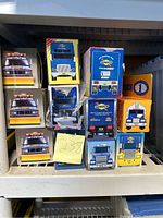 Photo showing multiple Sunoco toy truck models in boxes arranged on a shelf, with detailed visible front box art of different truck cab designs.