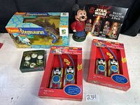 Full lot including boxed Poynter Stegosaurus, vintage Mickey Mouse figurine, Star Wars figure pack, Mickey Mouse walkie talkies, and small boxed mice figurines.