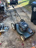Full length view of the Craftsman lawn mower showing overall condition and wheel design