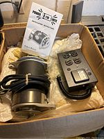 Power Mite 110V generator in box with attached cables, control box, and instruction manual