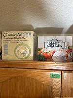 Boxes for Counter Art Insulated Dip Chiller and Magic Salad Maker set on a wooden cabinet