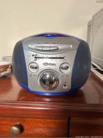 Front view of GPX Model C480 stereo cassette radio showing control buttons, tuning dial, speakers, and AM/FM radio scale.