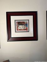 Framed art print by Tom Thomson hung on wall showing the full frame and artwork.