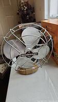 Front view of Seabreeze vintage electric table fan showing the protective metal cage and four-blade design.