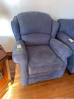 Front view of upholstered wing back arm chair in blue/gray fabric.