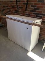 Exterior front view of the white Frigidaire chest freezer showing rectangular shape and hinged lid.