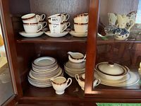 Full display of Alfred Meakin Kingsdale china including stacked plates, cups and saucers, and serving pieces on pantry shelves