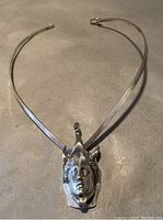 Full view of silver choker collar necklace with attached pendant