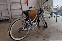 Full side view of cruiser bicycle showing frame, tires, saddle, fenders
