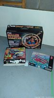 Photo of three K'NEX sets: Roller Coaster, Baja Desert Racer, and an unnamed third set.