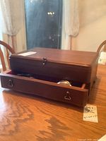 Wooden canteen with drawer slightly open showing some flatware inside