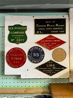 All seven builder plaques mounted on white board