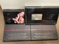 Four boxed kits: two Pink Diamond Neck and Chest Systems, one Forever Flawless Deluxe Manicure Kit, and one Forever Flawless Diamond Age Defying Beauty Kit.