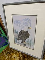 Framed limited edition print showing a bald eagle perched on a stump with trees and stylized eagle background.