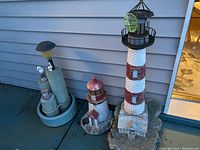 Wide view of all three garden ornaments in the lot showing various angles and relative sizes