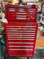 Front view of the red Mastercraft rolling tool storage cabinet showing top chest and base with multiple drawers