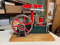 Front view of beam steam engine, showing flywheel, cylinder, beam and base