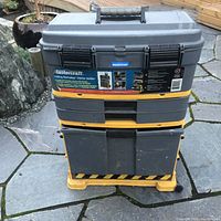 Front view of the closed Mastercraft rolling tool caddy showing the top handle and label.