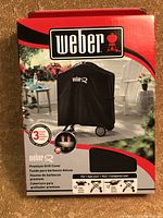 Front view of the Weber grill cover box showing brand, product image, and compatibility info.