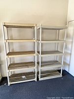 Two plastic shelving units side by side against a wall, showing their full height and shelf arrangement