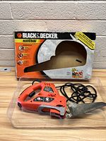Black & Decker jigsaw in front of original box showing branding and product information.