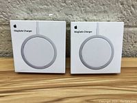 Front view of two Apple MagSafe Charger boxes side by side showing product image and labeling.
