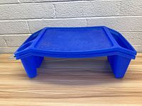 Front view of one blue plastic lap desk showing flat surface and compartments