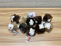 Lot of Gund plush key chains laid out showing different animal shapes and colors, all with key rings and tags